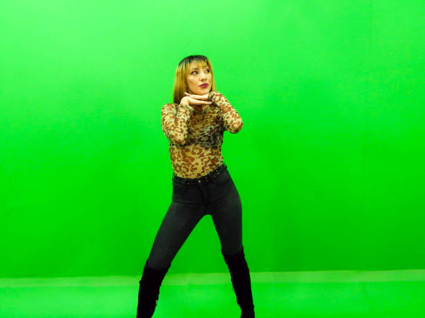 istock Woman posing with green background 1309625883