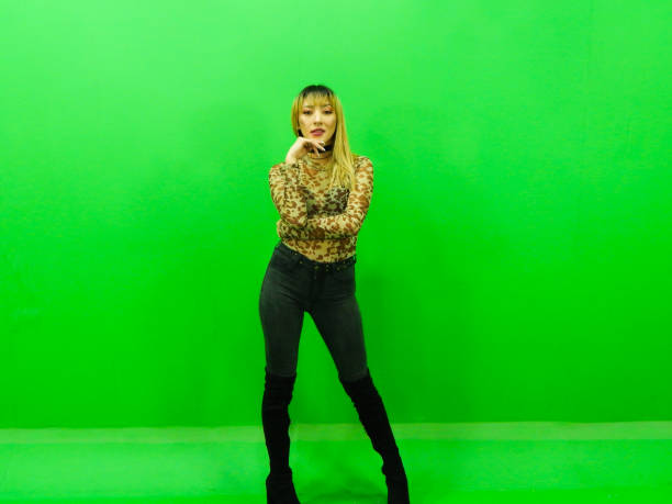istock Woman posing with green background 1309625884
