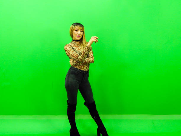 istock Woman posing with green background 1309625887