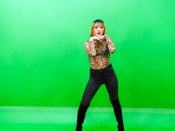 istock Woman posing with green background 1309625891