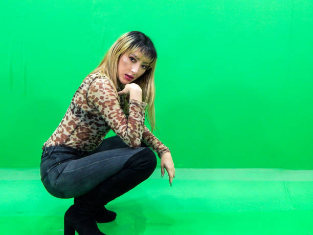 istock Woman posing with green background 1309626450