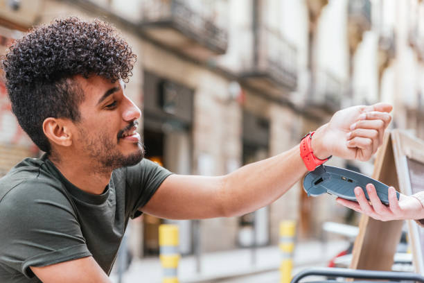 istock Latin man using a modern watch to pay on a cafe 1309626614