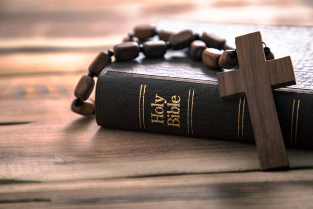 istock wooden cross with Holy Bible 1309629200