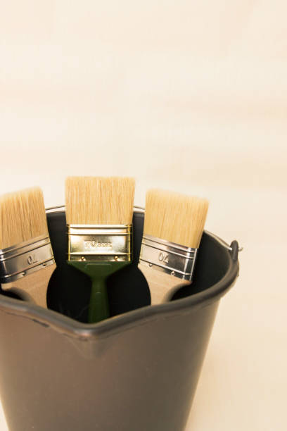istock Construction tool for working with wallpaper. Wide brushes in a bucket. 1309629320