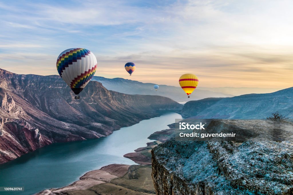 Hot air balloons flying over the Botan Canyon in TURKEY Hot Air Balloon Stock Photo