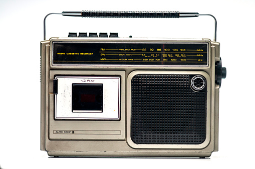 Old transistor radio isolated on white English translation: programs, volume, tape recorder (inscription in Russian)