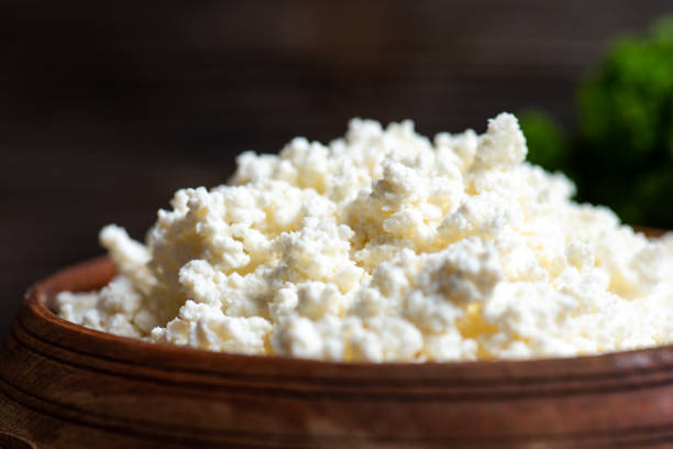 Crumbled young cow cheese Crumbled young cow cheese pieces in a bowl on a rustic table feta cheese block stock pictures, royalty-free photos & images