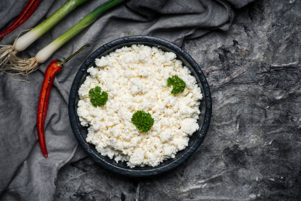 Crumbled young cow cheese in a bowl Crumbled young cow cheese in a bowl with spring onion and food ingredients feta cheese block stock pictures, royalty-free photos & images