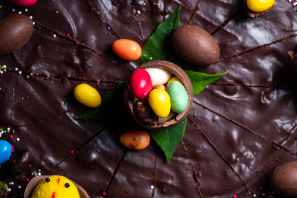 istock Chocolate Easter eggs on top of a chocolate cake dessert closeup 1309636477