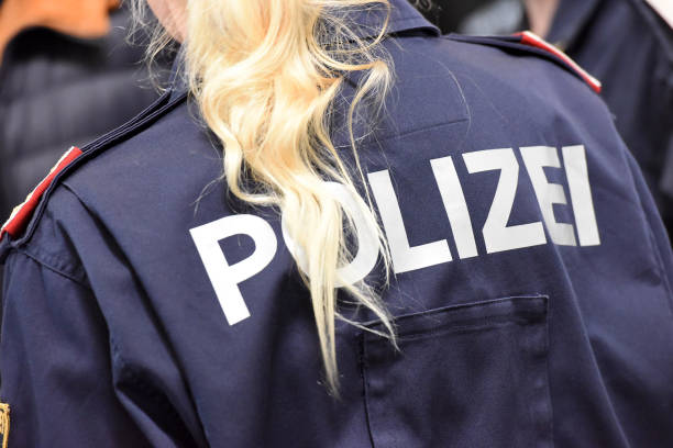 Female police officer from behind with blond hairs while control on  a street in Austria