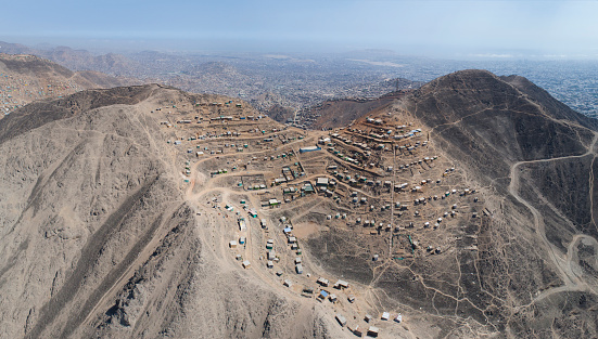 Aerial image of Lima Peru, shanty town in the hills. Image of Andes hills invaded. Small town, poverty.