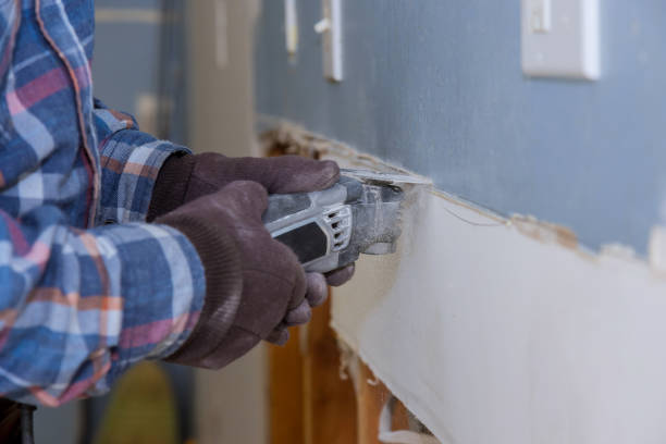 istock Home renovation service works on worker cutting plasterboard with construction electric power tools of replacement damaged drywall 1309646755