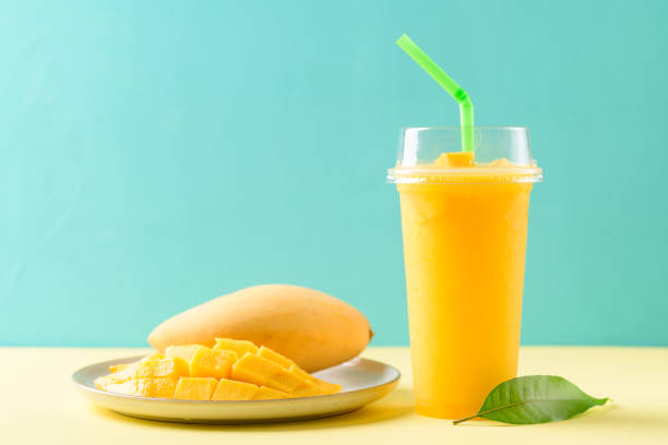 istock Fresh mango smoothie in a glass and sliced ripe mango fruit 1309646777
