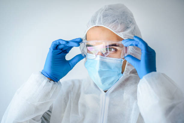 istock Young man in full protective costume and protective face mask. COVID 19 concept. 1309648810
