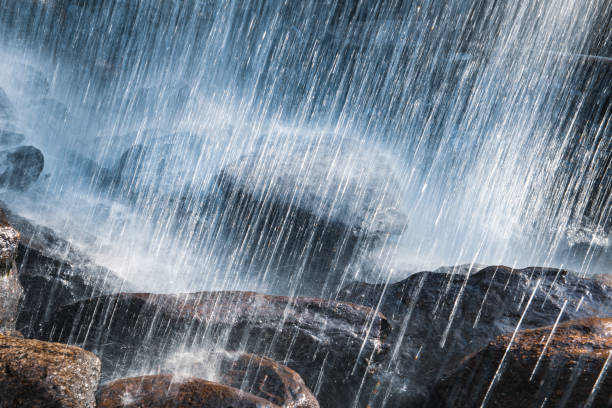 istock Shot from Behind Waterfall Crashing on Rocks Backlit Abstract 1309650415