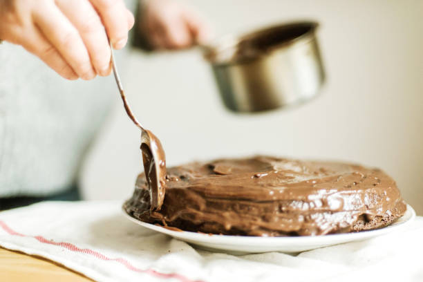 istock Woman  cooking a chocolate cake in kitchen at home. 1309651360
