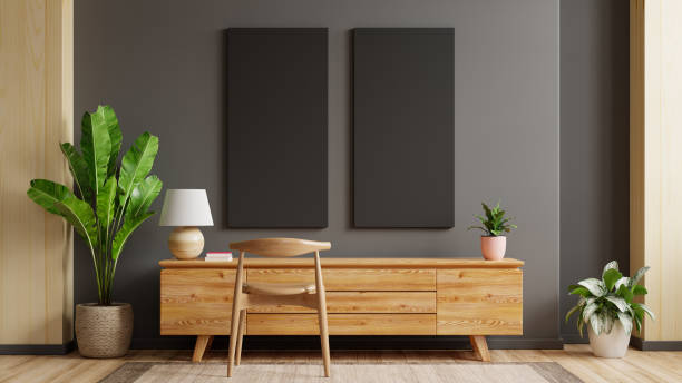 istock black Poster mockup with vertical frames on empty dark wall in living room interior with cabinet. 1309652368