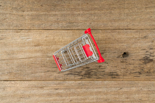 A shopping trolley on a wooden board background. Flat lay.