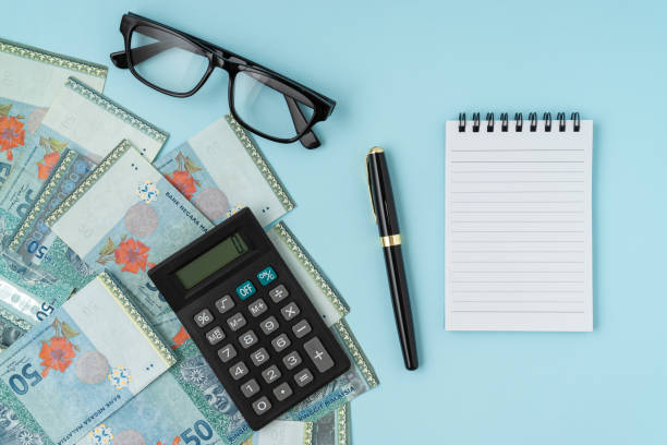istock Notebook and calculator with a bundle of MYR banknote. Business concept. Copy space. 1309659785