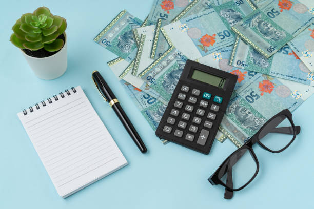 istock Notebook and calculator with a bundle of MYR banknote. Business concept. Copy space. 1309659907