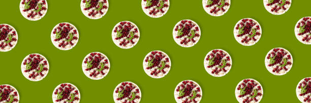 istock Abstract background from galett. Healthy breakfast with rice cake and pomegranate on black flat lay. Pop art 1309666541