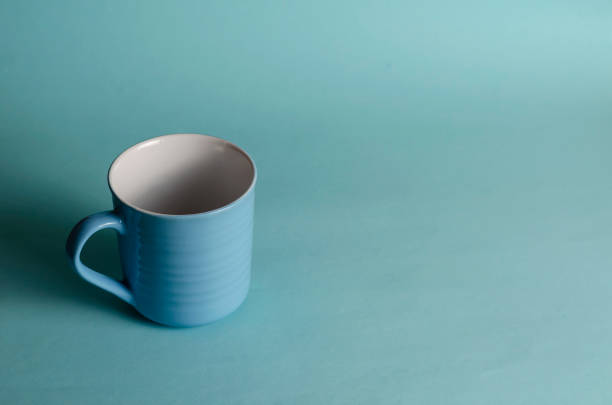 istock Minimalistic composition of a blue cup on a light blue backgroun 1309669874