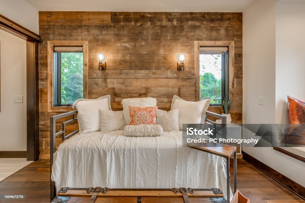 Upstairs area with trundle daybed Wood shiplap wall with barn door and wood flooring Bed - Furniture Stock Photo