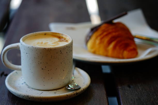 istock Coffee cup with milk in the morning and Croissant on table 1309672985