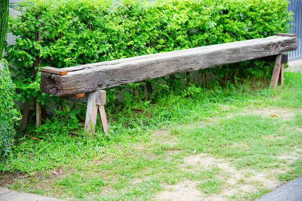 Old wooden bench in garden from Wooden pole.