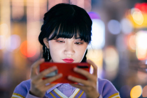 istock Teenager girl using phone at night 1309677825