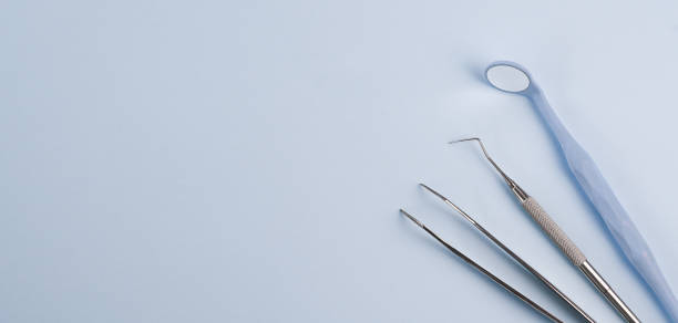 istock Dentist tools. Teethcare, dental health concept. Blue background top view copy space. 1309681982