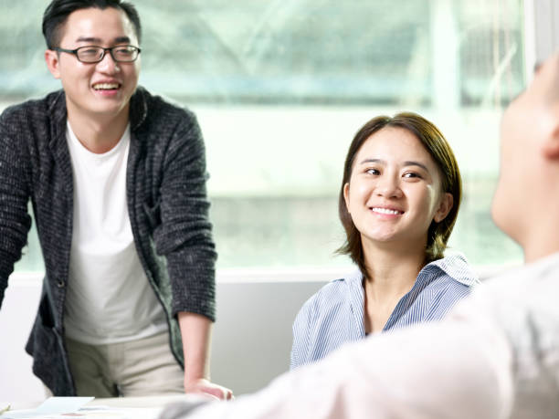 istock asian businesspeople conversing in office 1309682421
