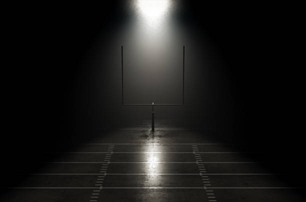 A concept showing posts on a reflective concrete lined american football field backlit by a single honeycomb spotlight - 3D render