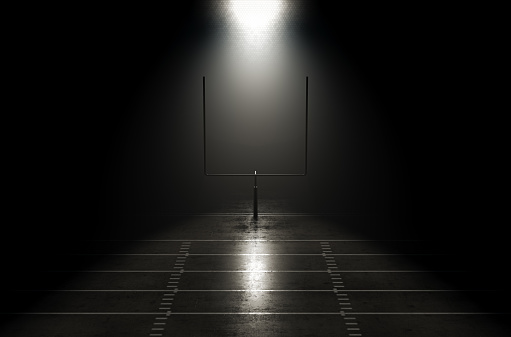 A concept showing posts on a reflective concrete lined american football field backlit by a single honeycomb spotlight - 3D render