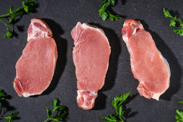 istock Raw pork loin. Pork meat on table. 1309685231