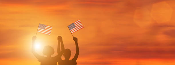 istock USA flag on sky background. American holidays 1309685356