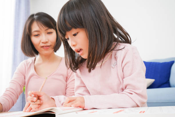 istock A girl and her mother studying at home 1309686270