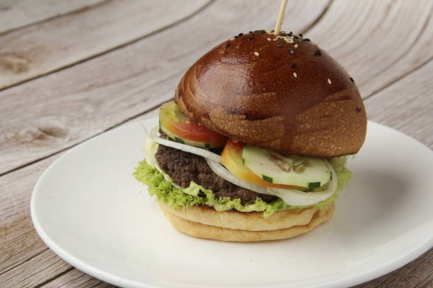 istock Freshly made giant hamburger sandwich with cheese and vegetables 1309687540