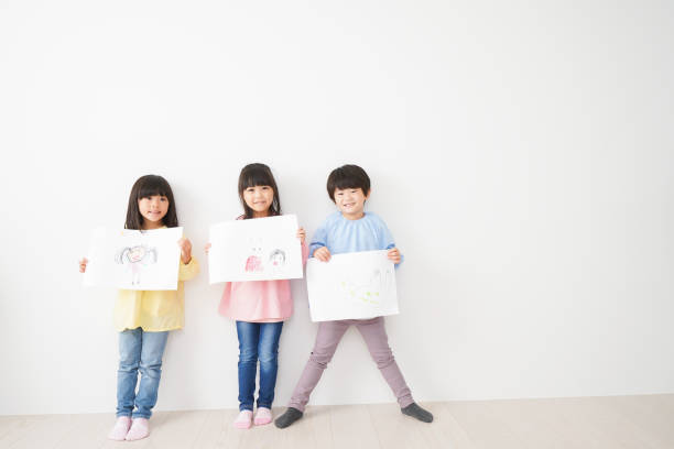 istock Little children showing their drawings 1309688420