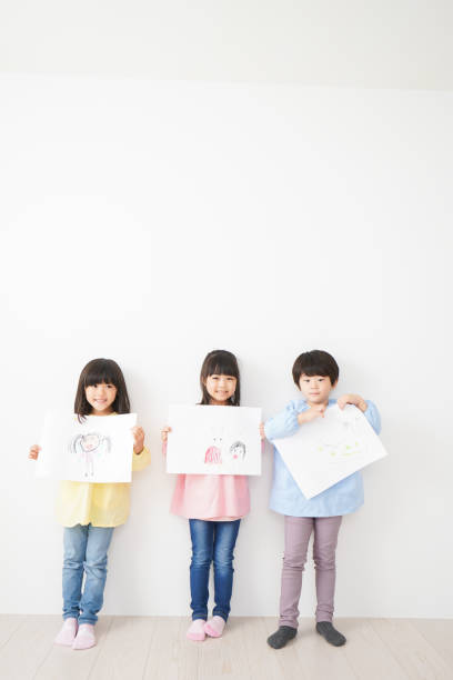 istock Little children showing their drawings 1309688427