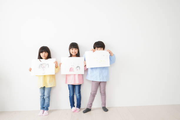 istock Little children showing their drawings 1309688429