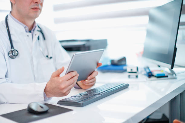 istock Physician holding digital tablet and checking results 1309689626