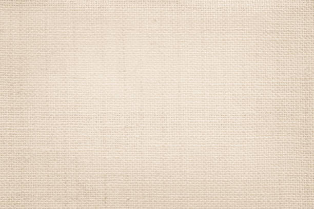 istock Jute hessian sackcloth canvas woven texture pattern background in light beige cream brown color blank empty 1309689634