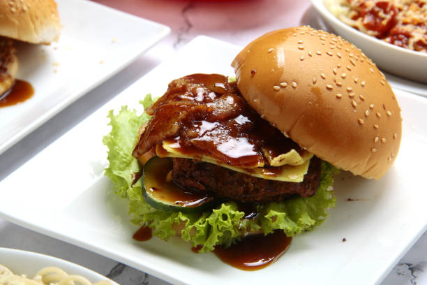 istock Freshly made giant hamburger sandwich with cheese and vegetables 1309690080