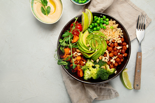 Stock photo showing close-up view of a white bowl of chicken and prawn noodle mixed vegetable stir fry.