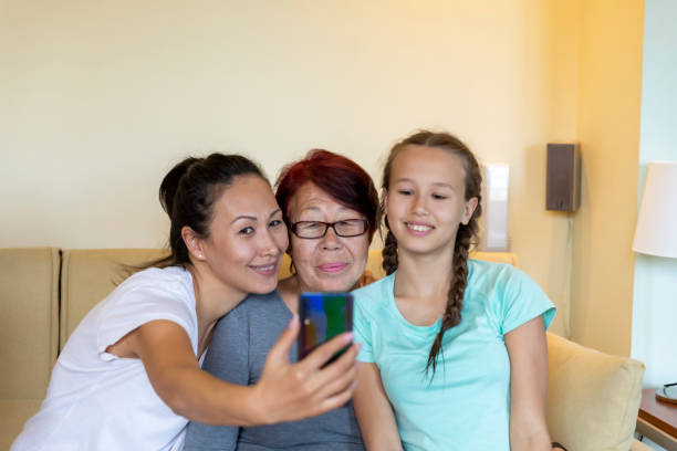 istock Multi-Generation Family is Enjoying Together While Capturing a Photo with a Mobile Phone. 1309693353