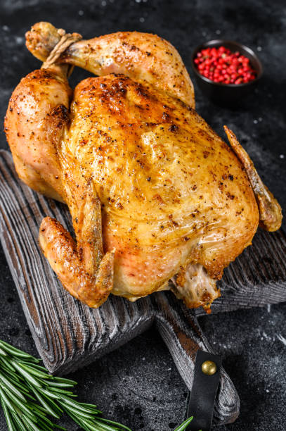 istock Grilled roasted whole Chicken.  Black background. Top view 1309694814