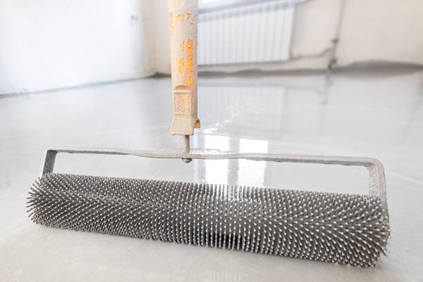 istock Close-up leveling tool for self-leveling floor. Leveling with a mixture of cement floors with a needle roller 1309695146