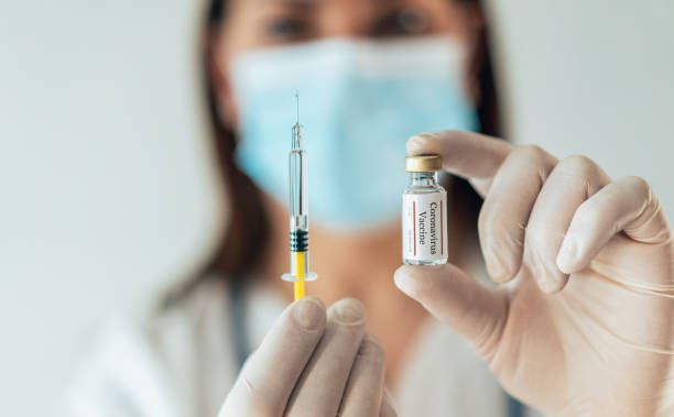 istock Preparing injection with covid-19 vaccine 1309697308
