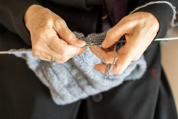 She's sewing a cute dress to her son or granddaughter